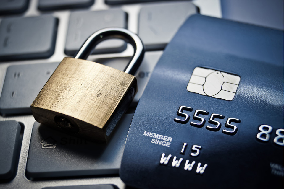 Lock with key is laying on visa cards