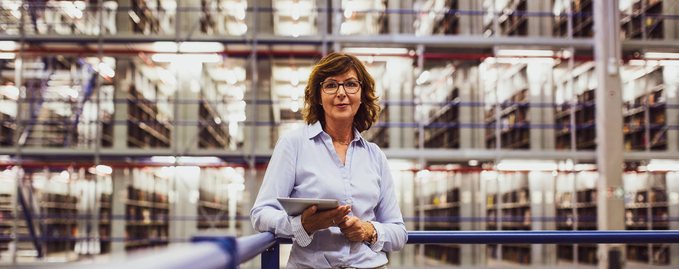 Warehouse manager using a tablet for inventory management
