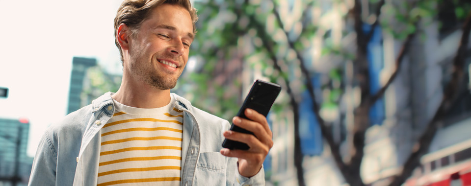 Smiling man uses telecommunication services