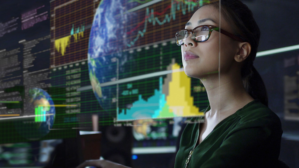 Woman watching risk monitoring data on screen