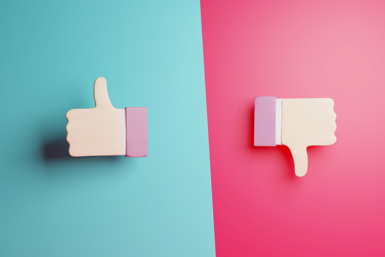 3D illustration of two hands giving a thumbs up and thumbs down, symbolizing automated risk decisions & portfolio evaluation