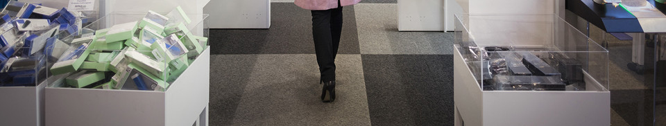 Woman in telecom store—subscription fraud risk during in-store onboarding and device sales.