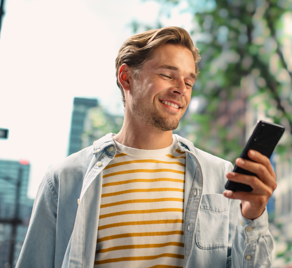 Man smiling at his smartphone