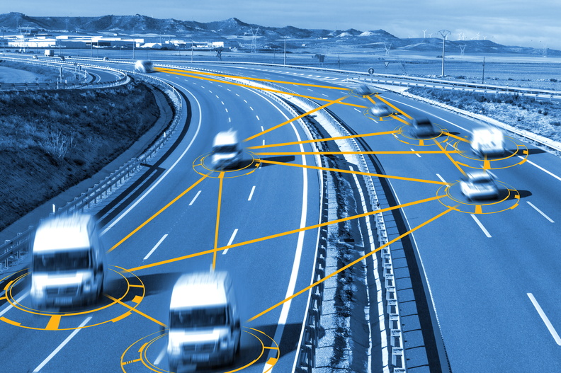 Smart highway technology with interconnected vehicles on a modern roadway, showcasing traffic management systems.