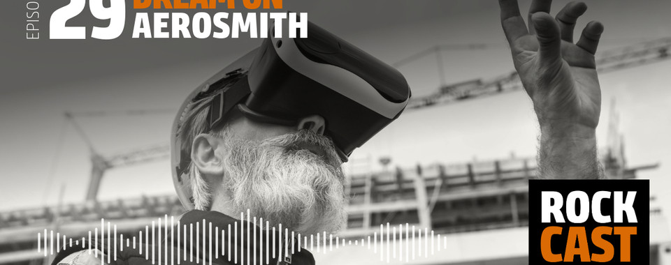 A man on a construction site with VR glasses. Overlay text reads "Episode 29 Dream On Aerosmith."