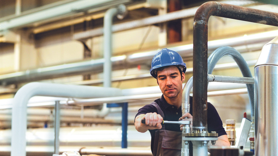 Worker assembles pipes and tubes