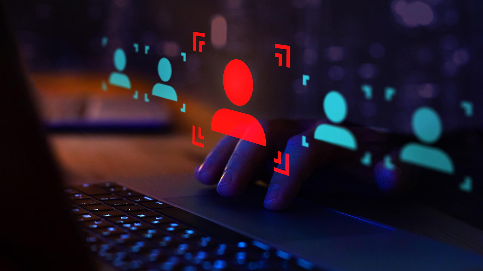 aptop, with digital user recognition symbols illustrating biometric technology in action.