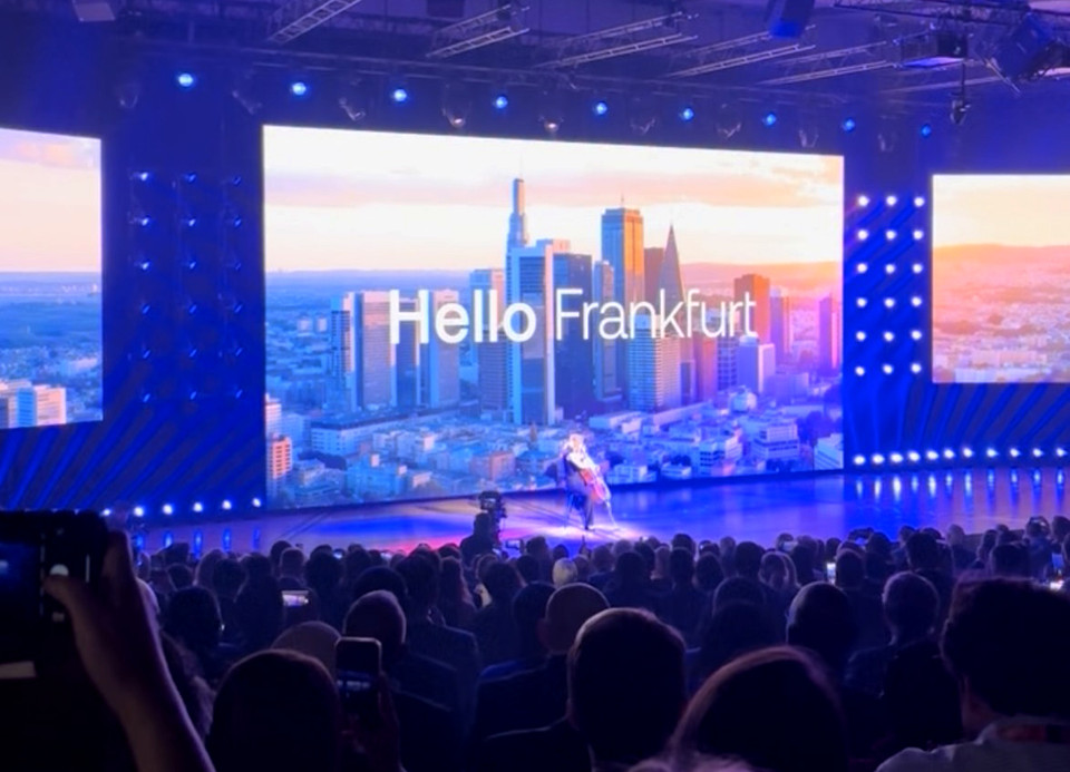 Audience at Sibos 2025 in Frankfurt with city skyline display and 'Hello Frankfurt' message on stage backdrop.