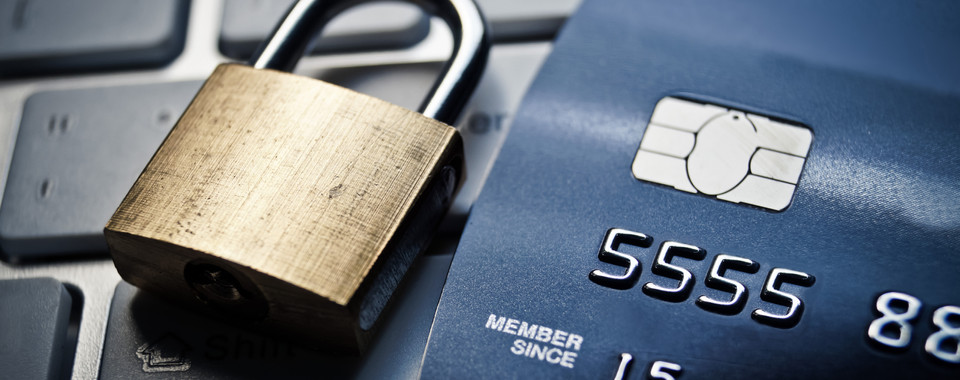 Lock and Credit card laying on computer keyboard