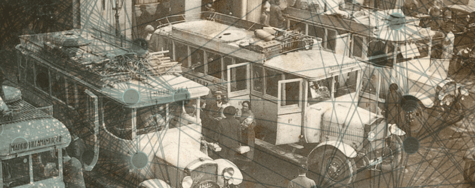 A historic yard with parked trucks being unloaded