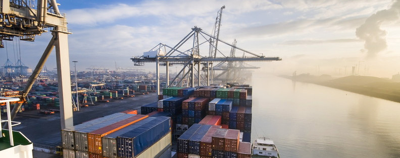 Blurred image of shipping containers with digital trading graph, symbolizing interconnection through data.