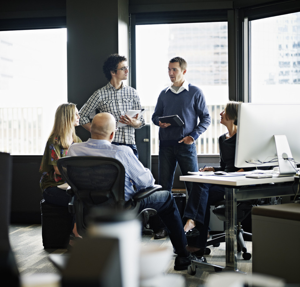 A group of people talking in an office