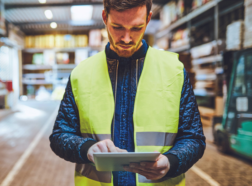 Workers in warehouse at tablet