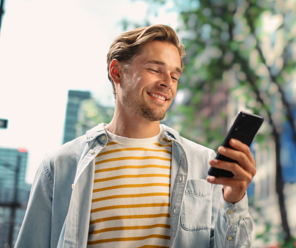 Man smiling at his smartphone