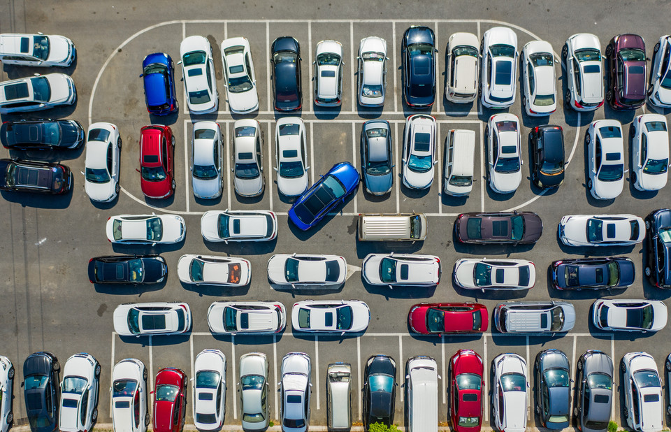 Aerial view of a crowded yard filled with various cars, showcasing a mix of colors and styles.
