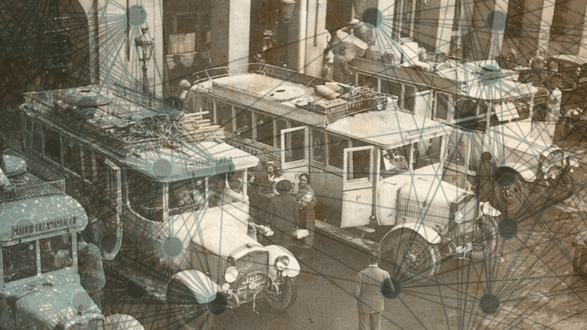 A historic yard with parked trucks being unloaded