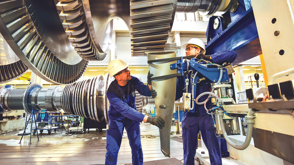 Two workers mount rotor blades