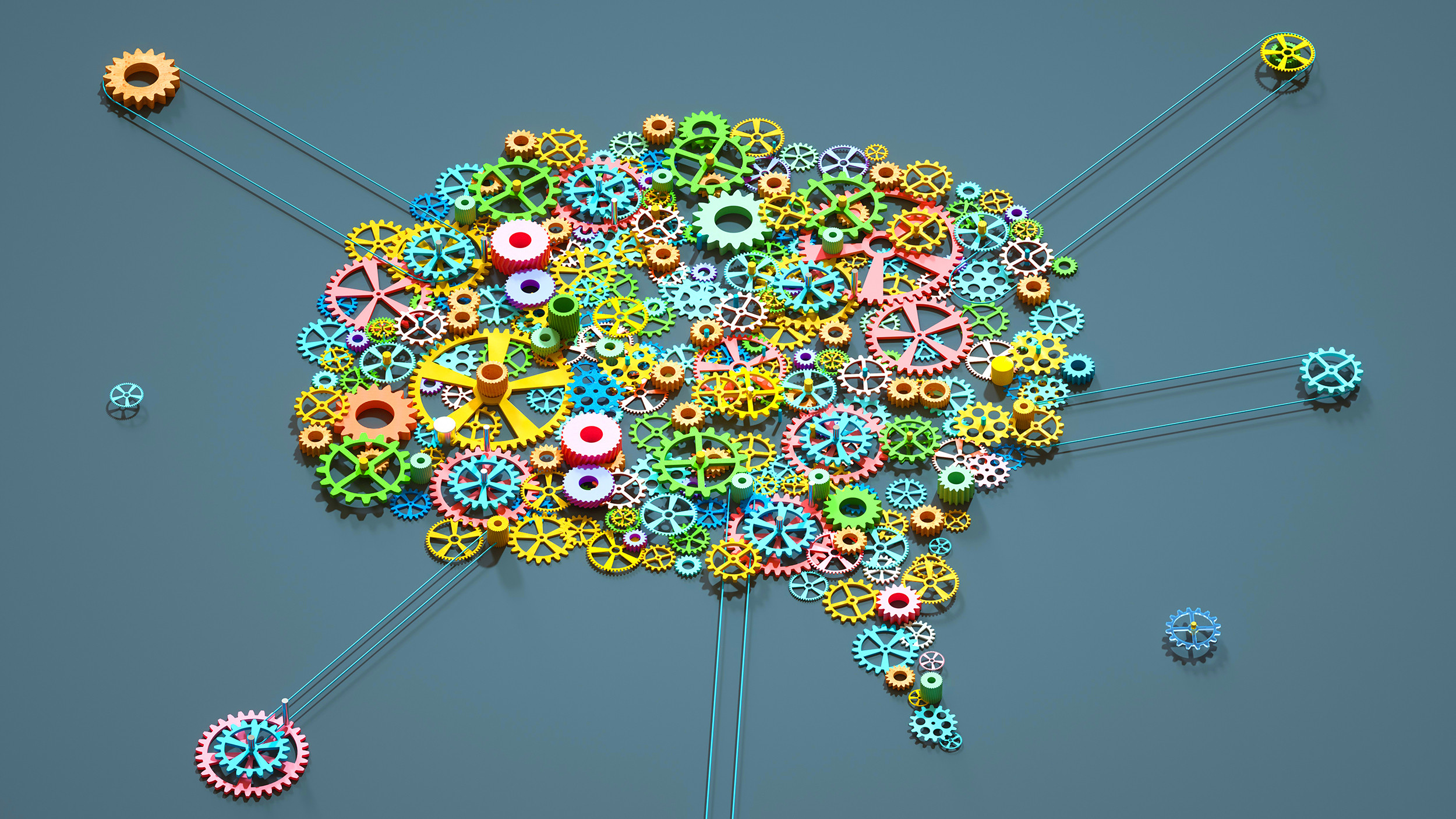 Colorful gears forming a brain shape, symbolizing creativity, innovation, and mechanical engineering concepts.