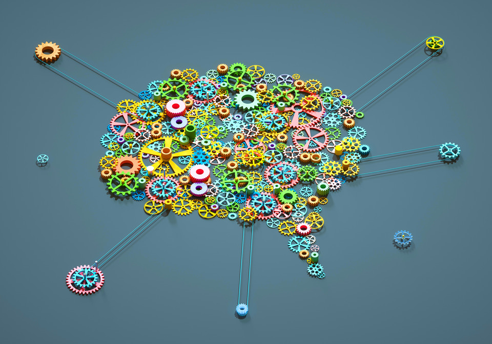 Colorful gears forming a brain shape, symbolizing creativity, innovation, and mechanical engineering concepts.