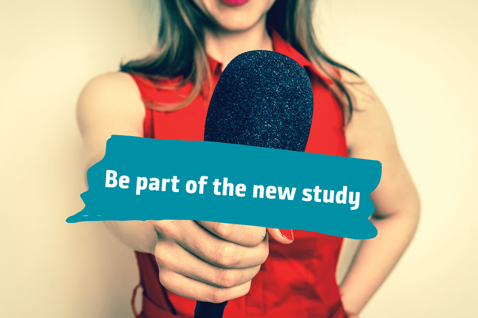 Close-up of a woman in a red dress holding a microphone, ready for an interview or public speaking event.